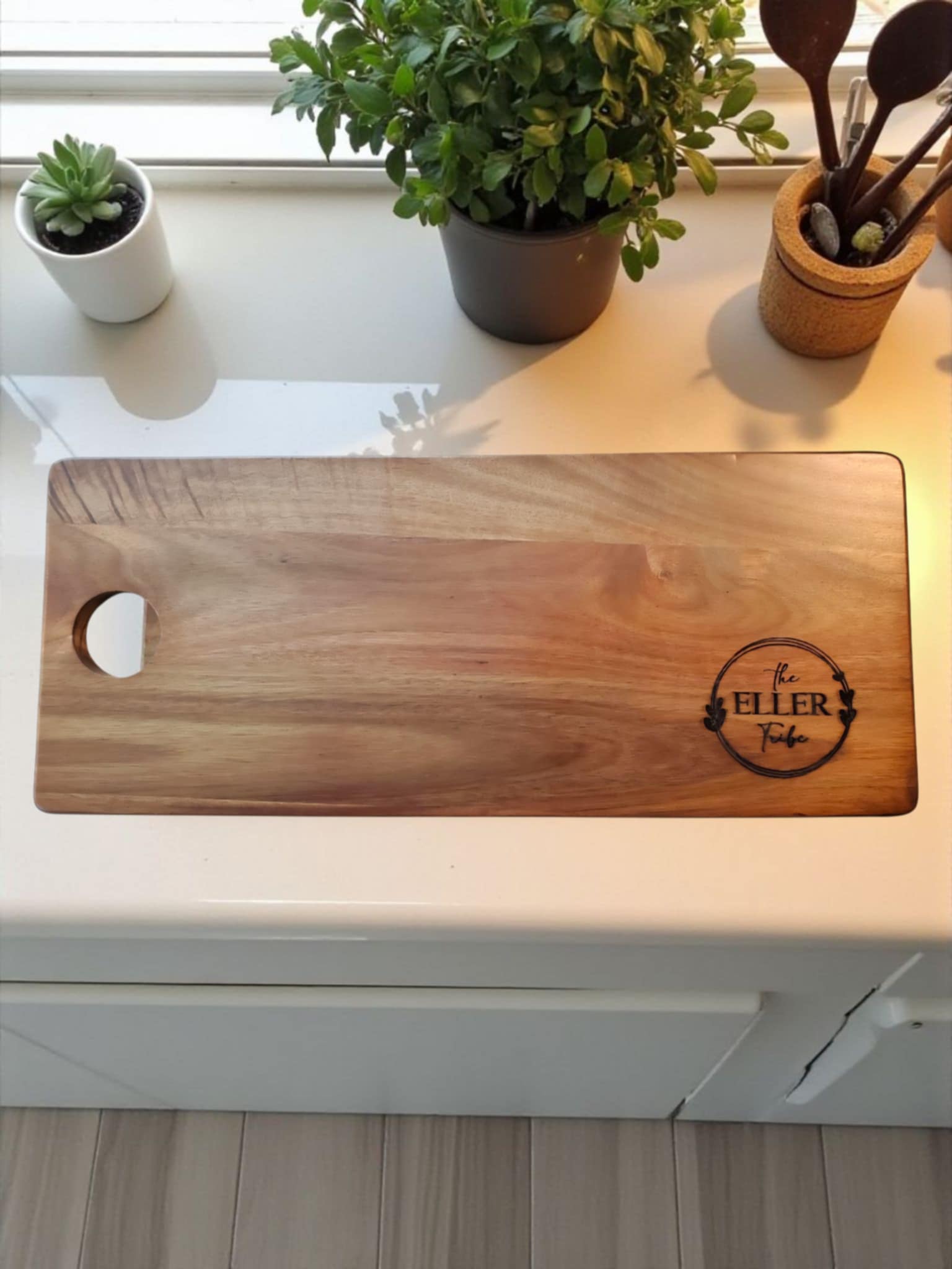 Acacia Cheese Board laser engraved with the last name of Eller