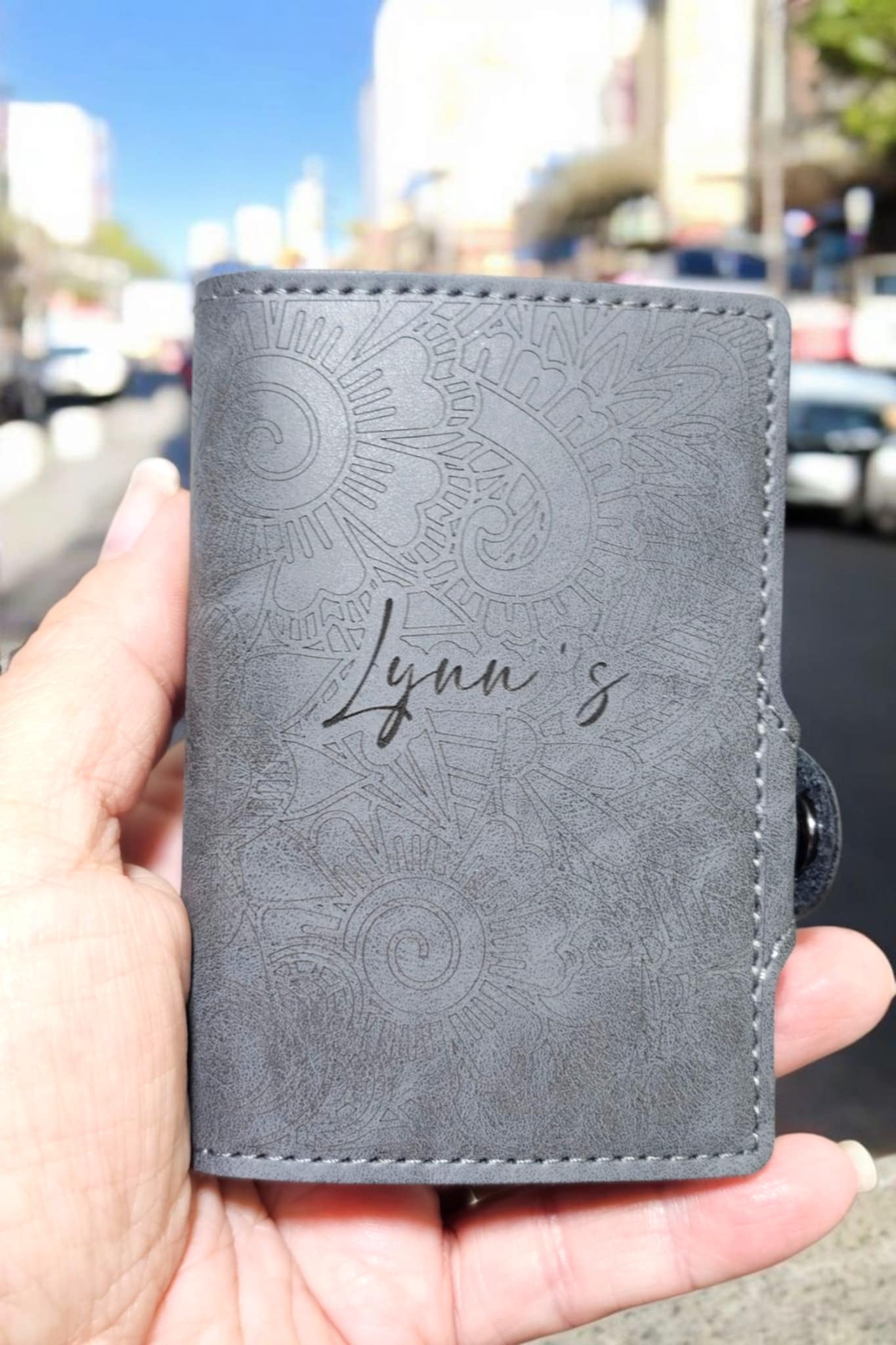 Gray RFID wallet fully laser engraved with the name Lynn’s across the front