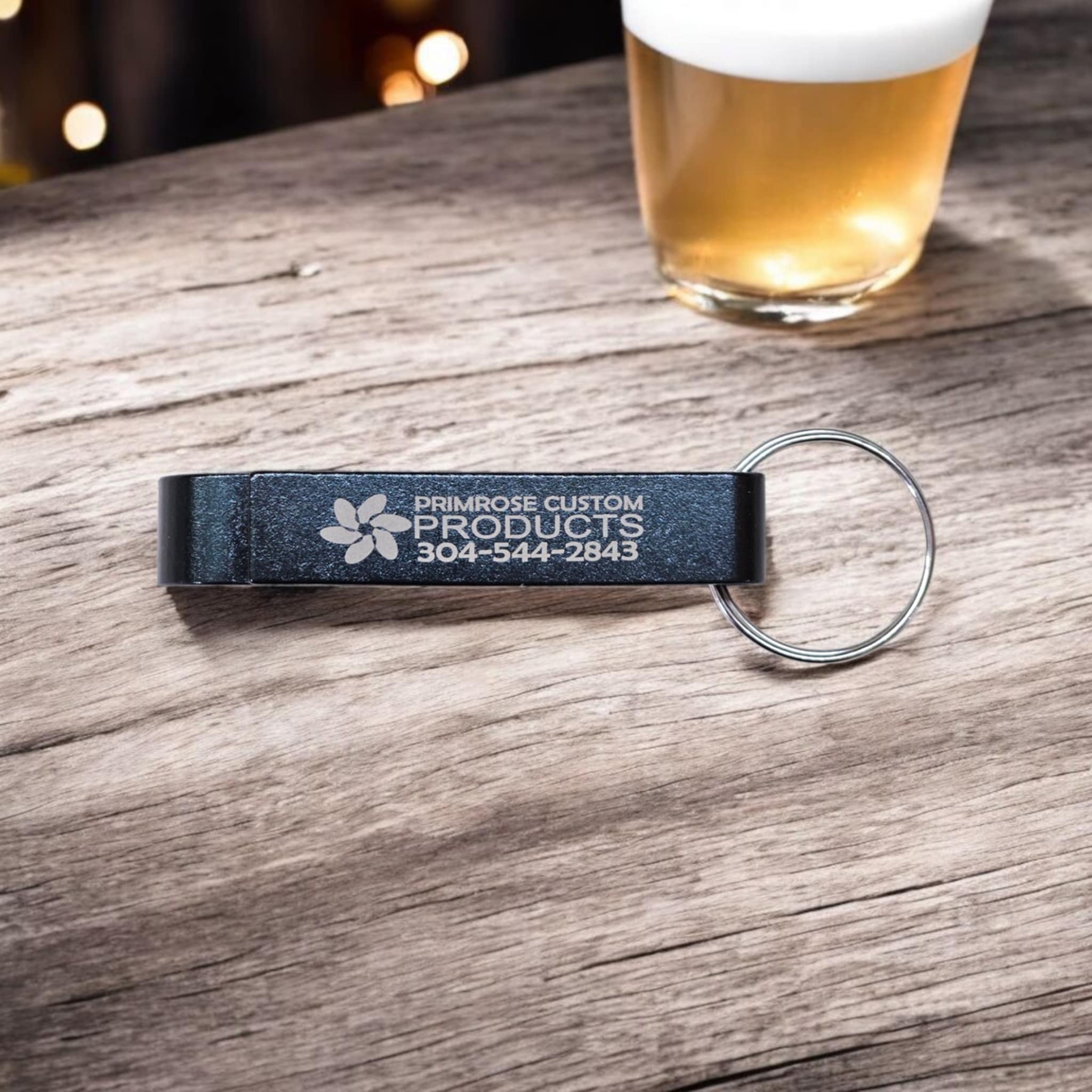 Black gooseneck bottle opener keychain, with Primrose Custom Products engraved on it