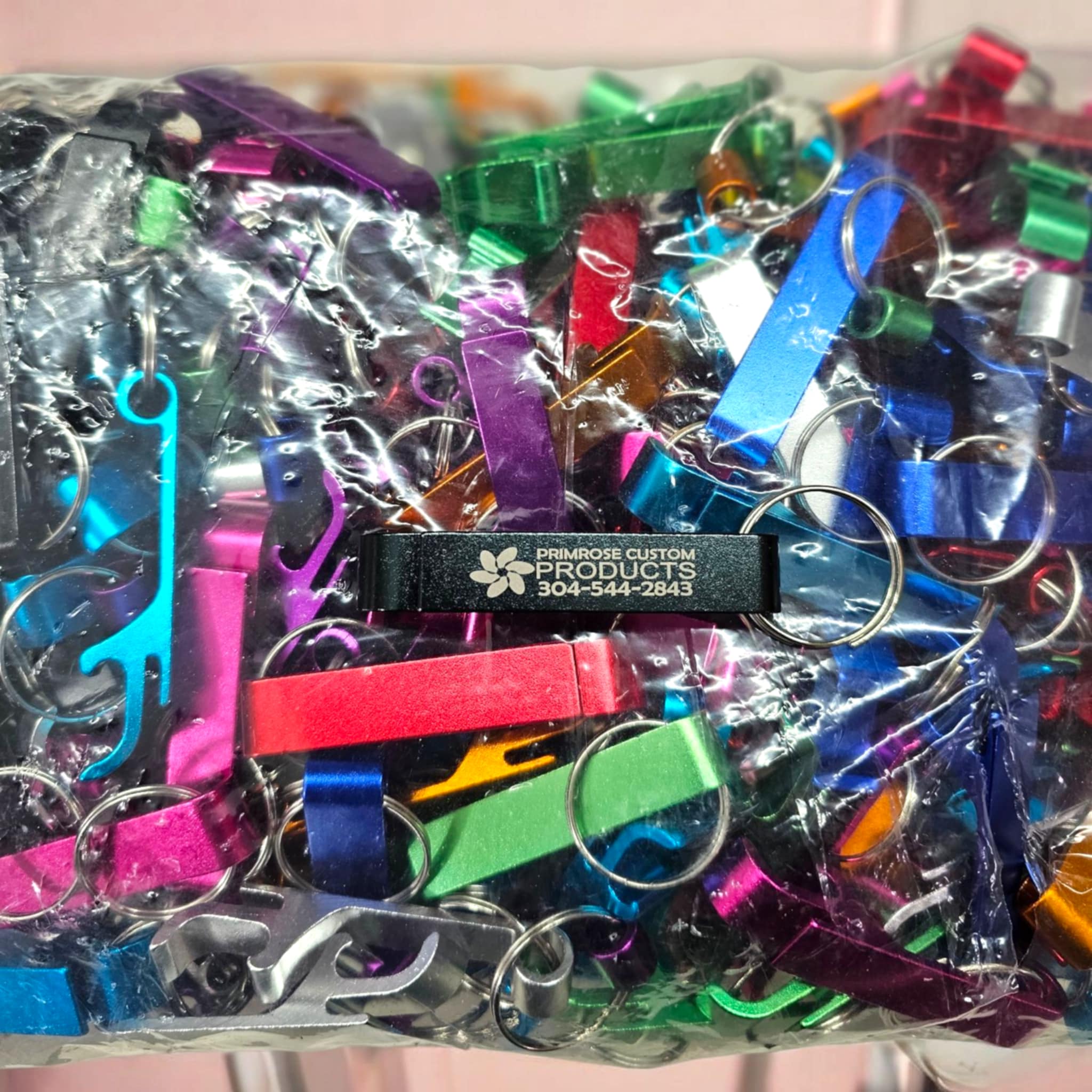 Bag of Goose Neck Bottle Opener Keychains in multiple colors