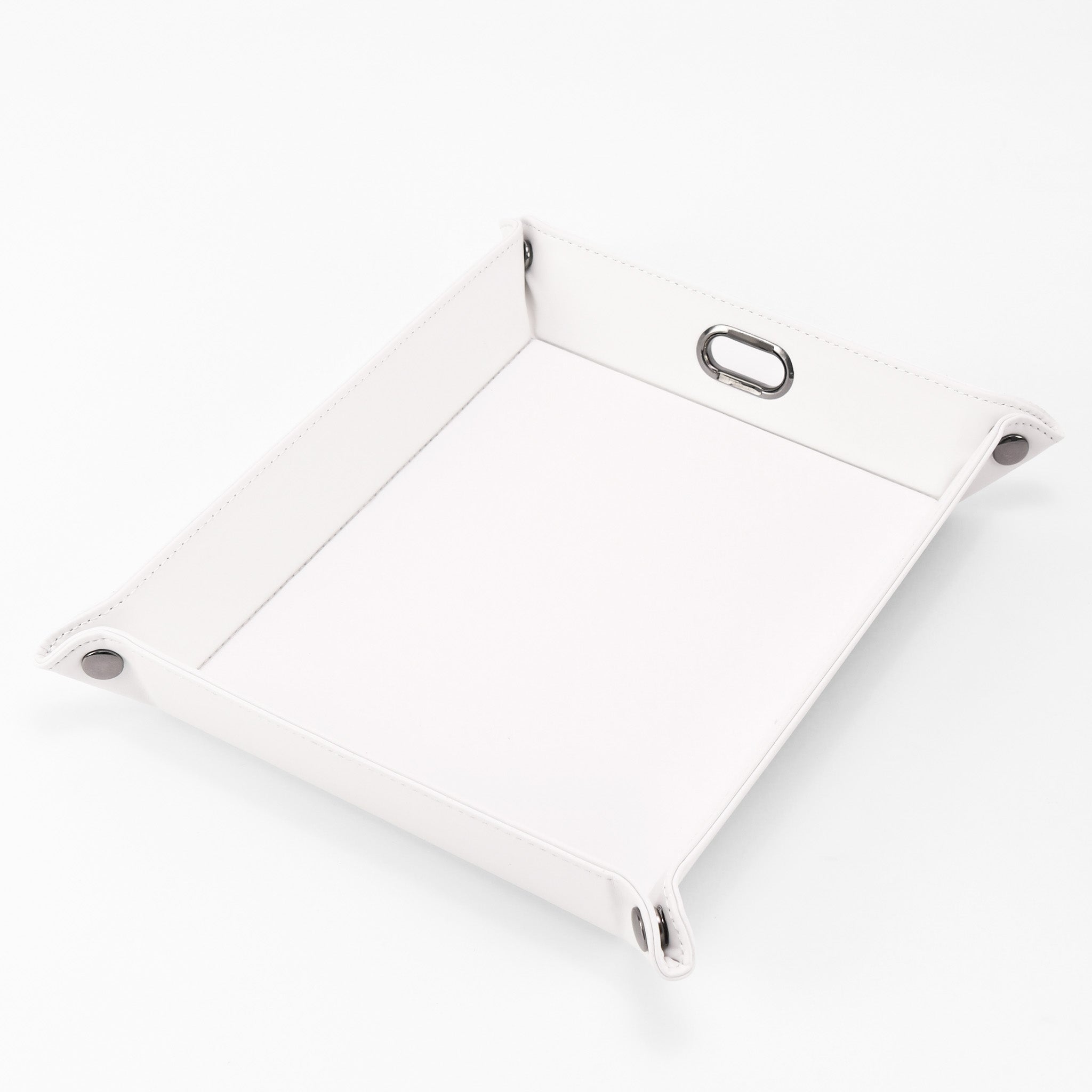 A white faux leather rectangular tray with a silver metal D-ring handle on the long side and silver corner grommets, shown on a seamless white background.